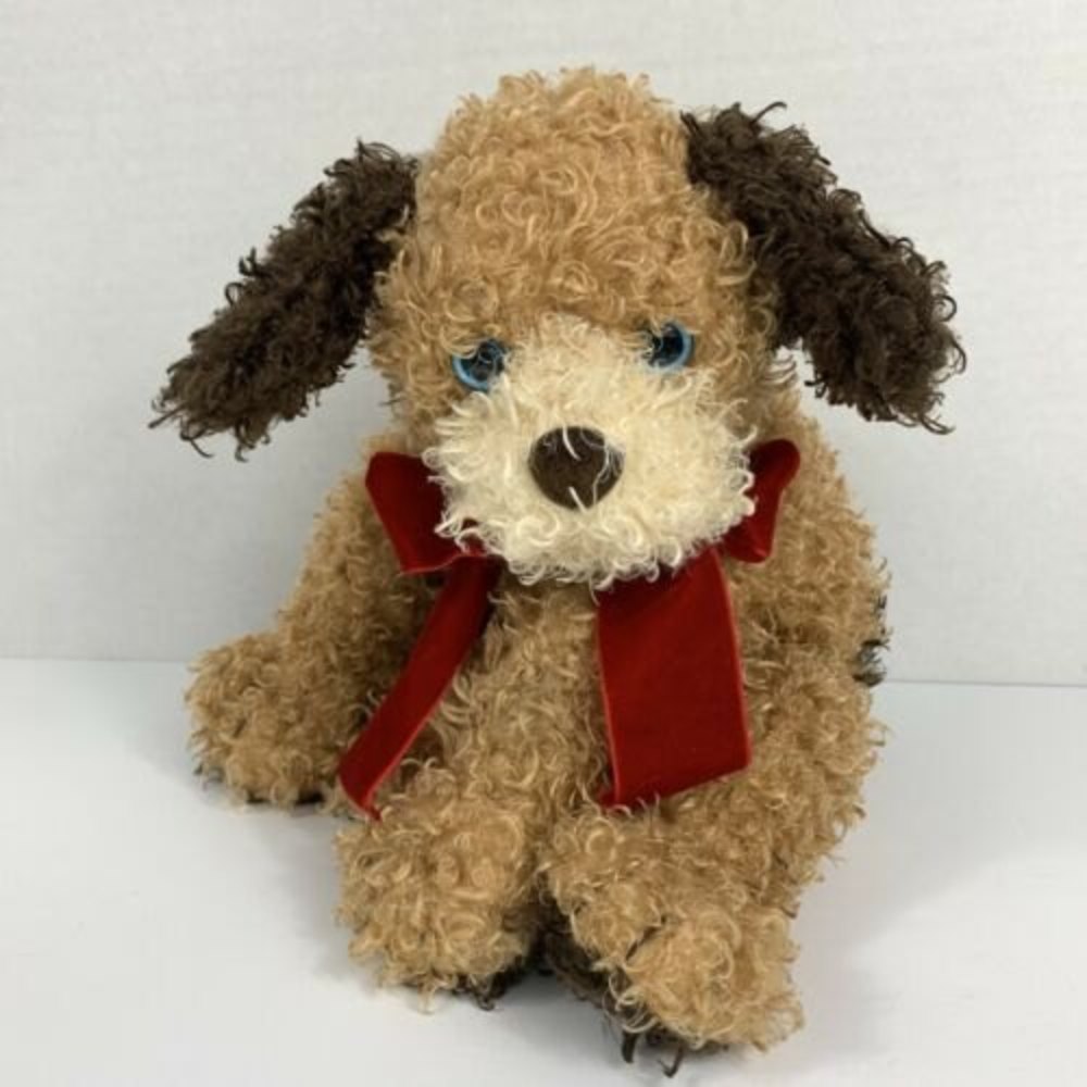 ty tan dog with red velvet bow and blue eyes